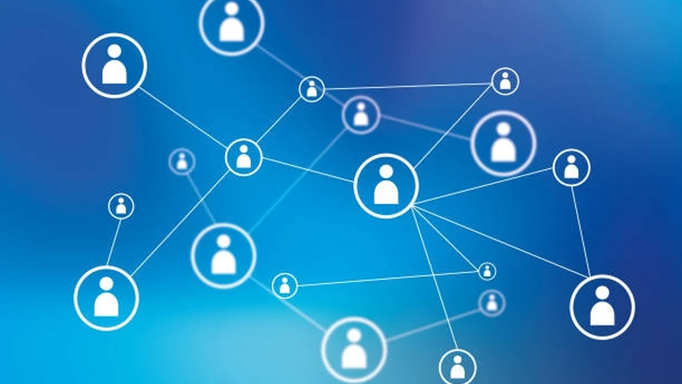 A network diagram of connected people icons in a distributed partnership pattern on a deep blue field.